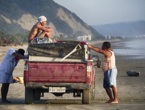men with red truck Canoa, Ecuador 2018, Nossi Travel Abroad