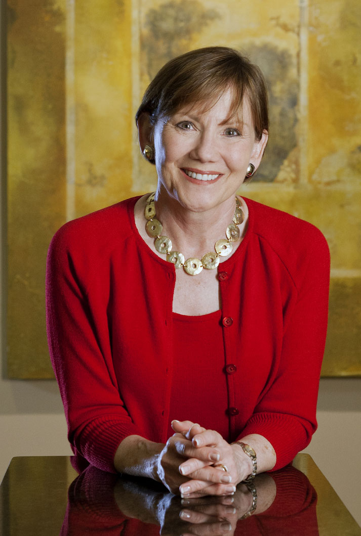 Barbara Paul cover photo in at her office wearing red