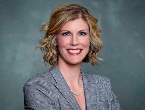 corporate headshot on gray background of attorney Joy Longnecker