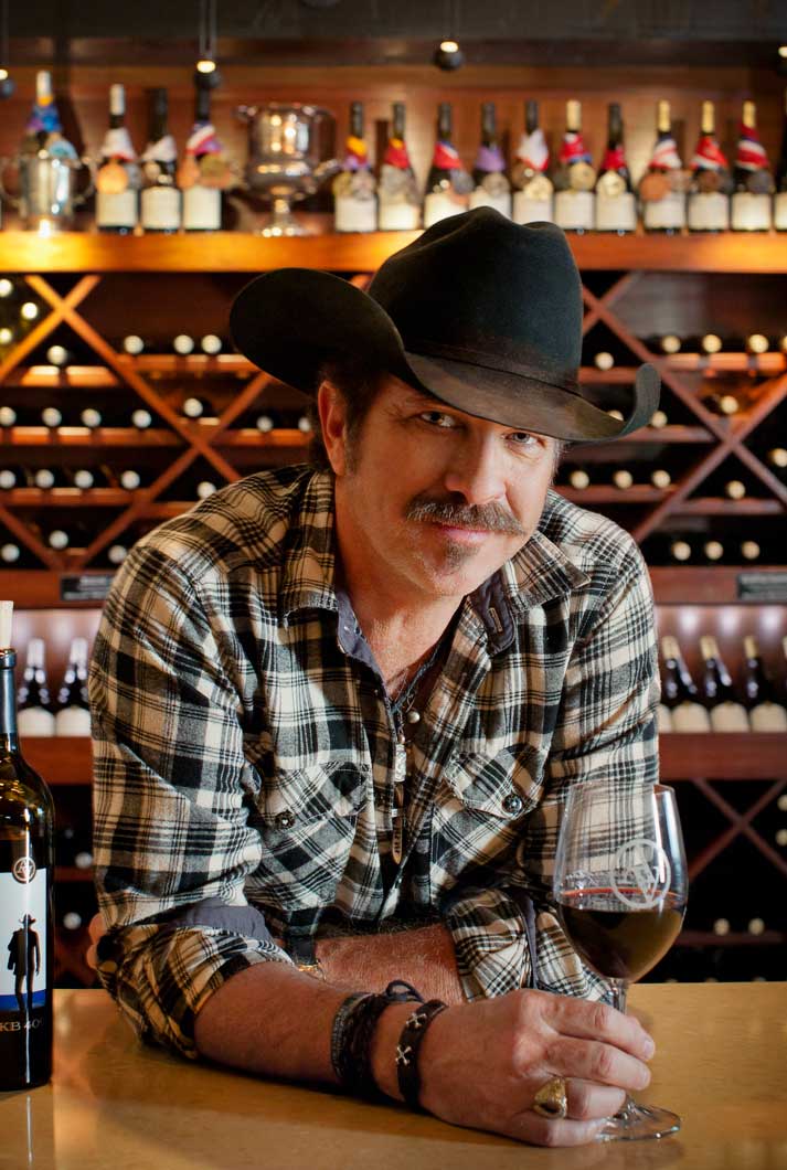Kix Brooks leaning on the bar in the tasting room at Arrington Vineyards