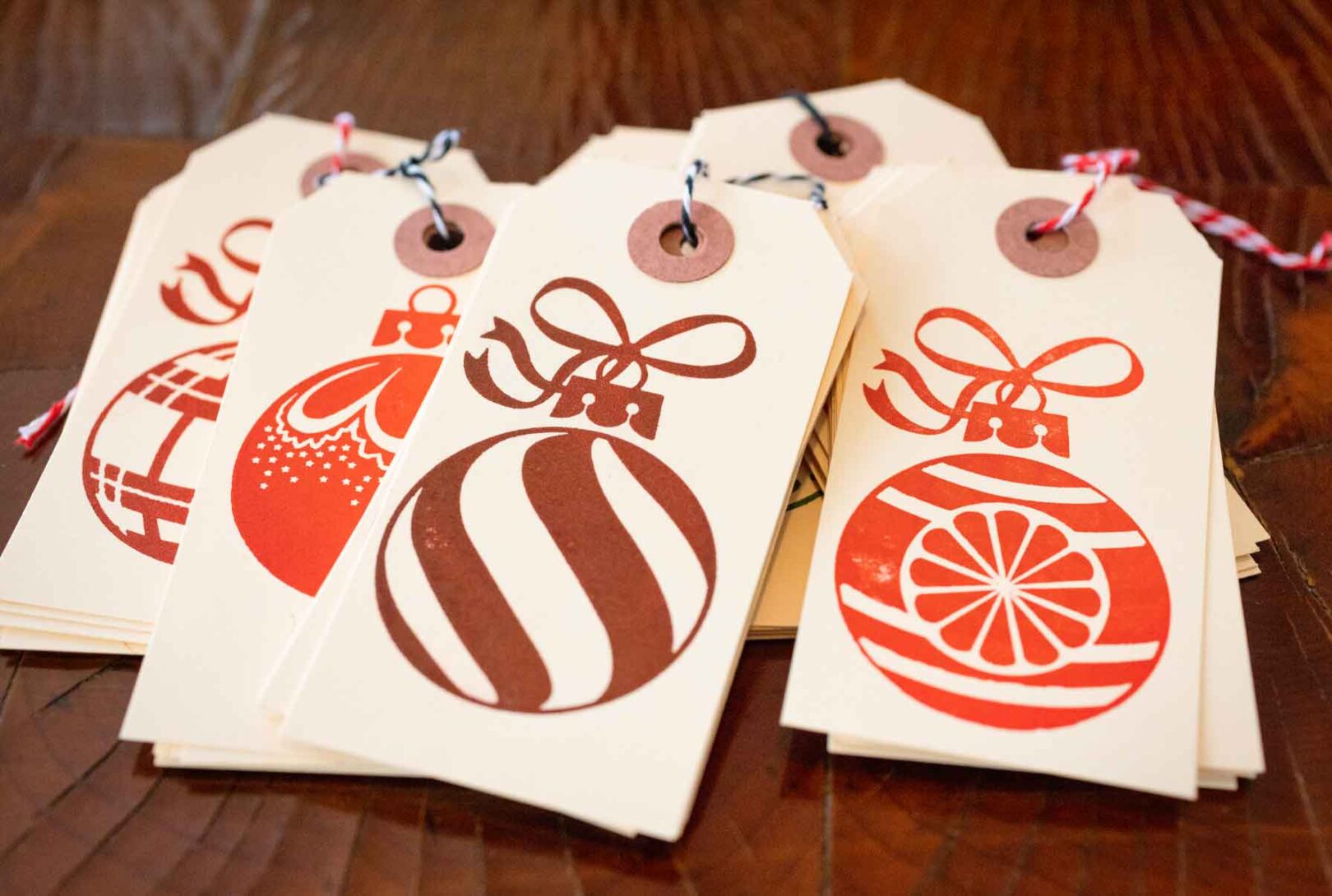 A set of Christmas gift tags with ornaments on them for product marketing