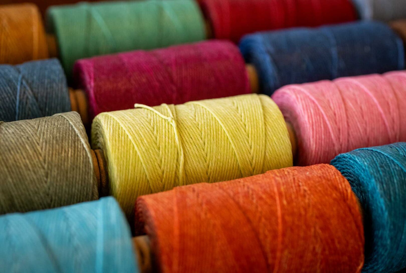 Colorful spools of thread on a table.
