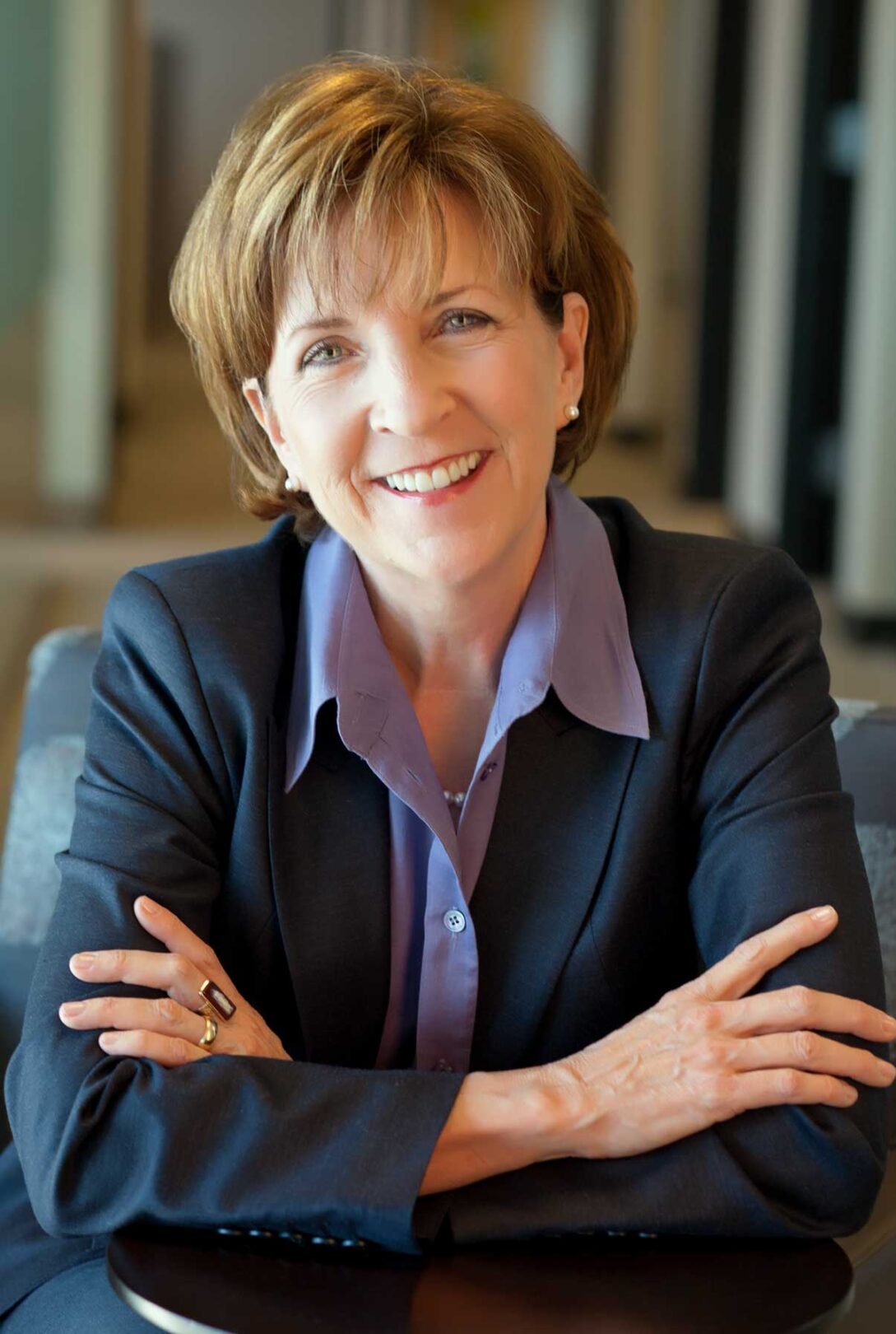 A woman in a business suit sitting at a table.