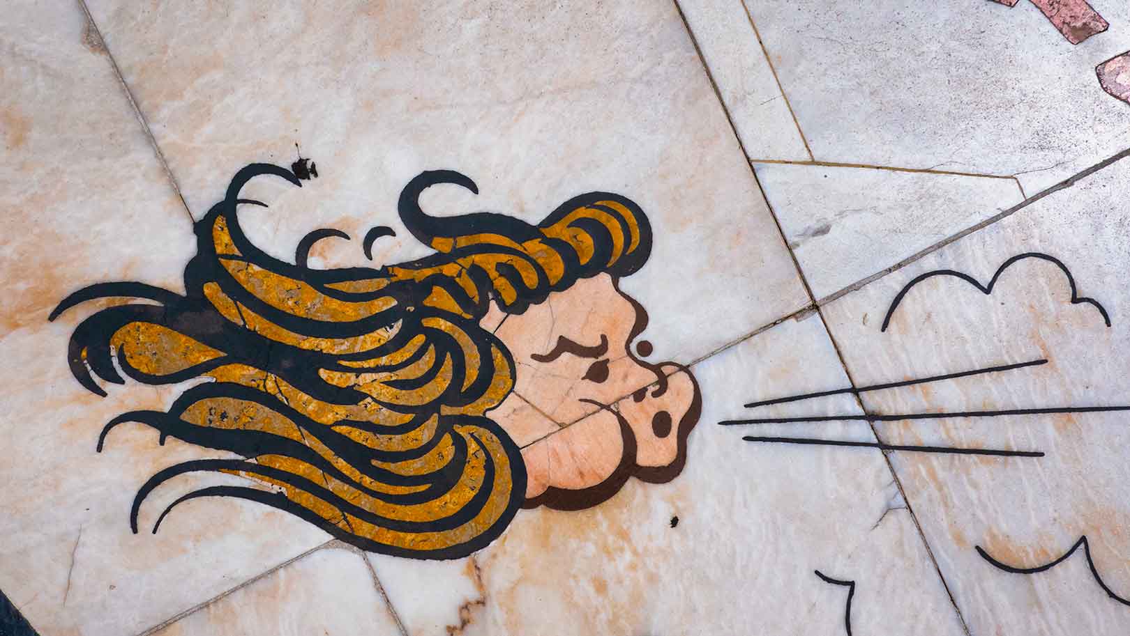 A tile with a head blowing air.