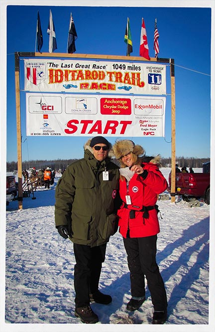 Payge McMahon with her brother Bryan underneath the Iditarod starting banner in Alaska