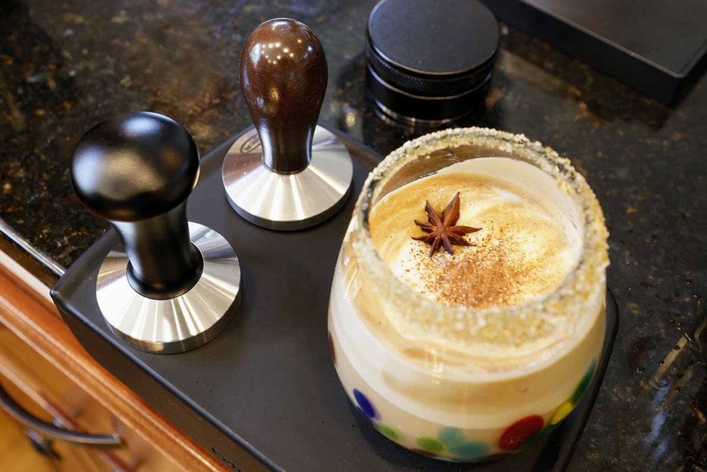 ginger-spiced latte in a glass with an orange salted rim