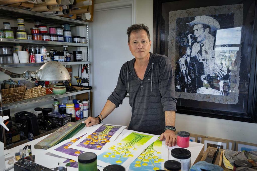 Artist in studio at table