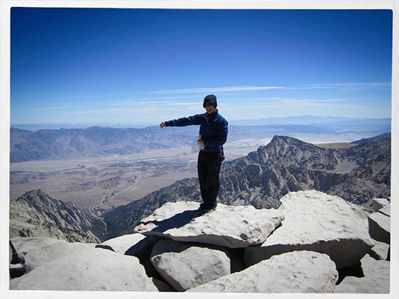 Payge McMahon on a cliff at Mt. Whitney in California